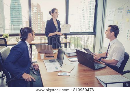businesswoman presentation to a group in meeting.