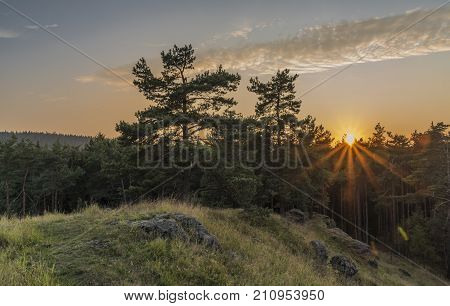 Sunset near Dominova skalka in Slavkovsky Les mountains in autumn evening