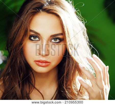 young cute blonde woman on green palm background smiling happy, lifestyle peole concept close up