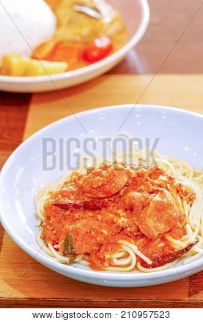 Spaghetti and sausages with sauce on plate