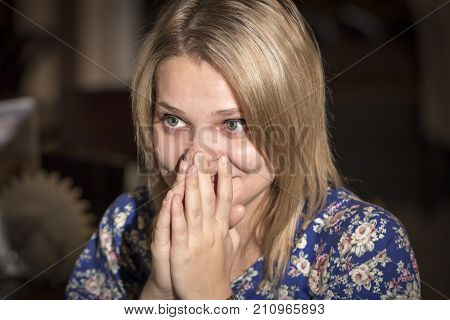Surprised young woman covering her mouth with hands Toned