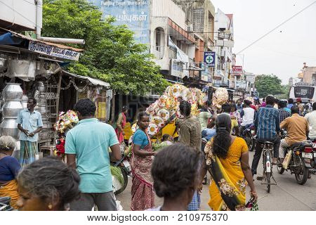 PONDICHERY PUDUCHERY INDIA - SEPTEMBER 09 2017. Unidentified man woman at his outdoor shop to sell umbrella in the main market of the city in south of India Asia.