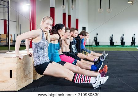 Confident Woman Practicing Triceps Dips With Friends