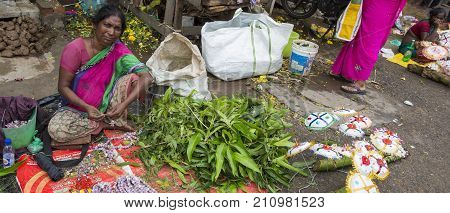 PONDICHERY PUDUCHERY INDIA - SEPTEMBER 09 2017. Unidentified man woman at his fruit and or vegetables shop in the main market of the city in south of India Asia.