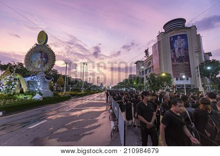 BANGKOK THAILAND - OCTOBER 26: Unidentified mourners in black walk near Ratchadamnoen Avenue for the cremation of Rama 9 the former king in Bangkok Thailand on October 26 2017.