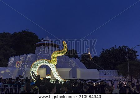 BANGKOK THAILAND - OCTOBER 26: Unidentified mourners in black walk near Pom Mahakan for the cremation of Rama 9 the former king in Bangkok Thailand on October 26 2017.