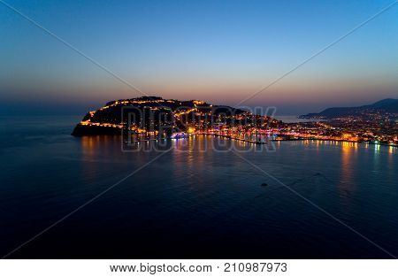 Turkish Alanya. The Seljuk fortress on the peninsula in the light of the night lights.
