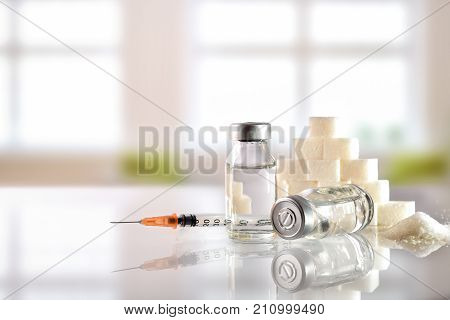 Insulin Vials And Syringe On White Table With Background Windows