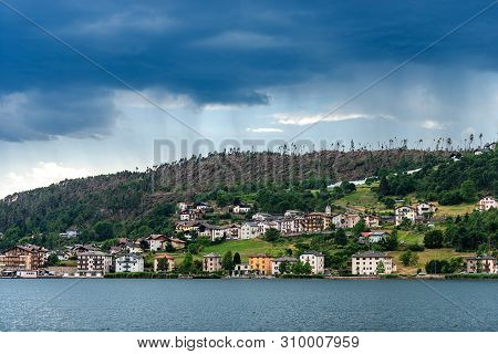 Serraia Lake (lago Della Serraia) And The Small Town Of Baselga Di Pine With The Trees Fallen From T