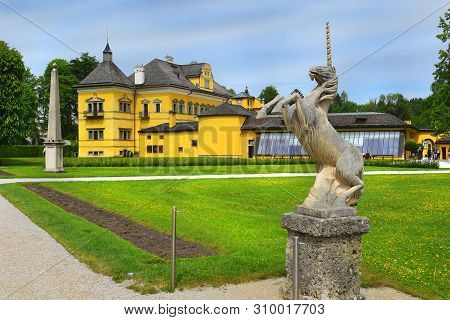 Salzburg, Austria - May 25, 2019 : Sculpture Of A Unicorn In The Park On The Background Of The Hellb