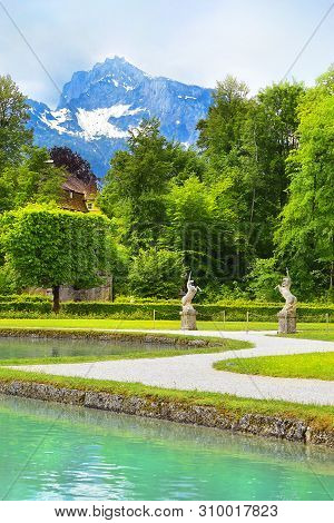 Salzburg, Austria - May 25, 2019 : Sculptures Of A Unicorn In The Park On The Background Of The Moun