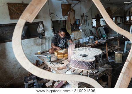 Gianyar,bali/indonesia-may 30 2019: A Guitar Craftsman Creating A Sketch On The Guitar Body At The G