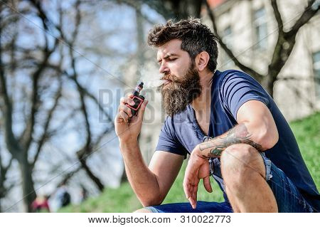 Smoking Device. Man Long Beard Relaxed With Smoking Habit. Man With Beard Breathe Out Smoke. Clouds 