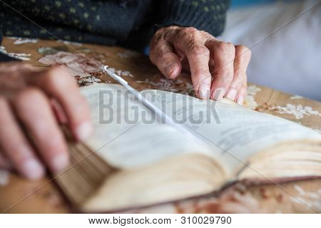 Old Woman Hands On The Open Prayer Book (christian Prayer Book In Ukrainian). Reading The Book. Pray