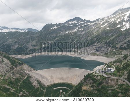 Dam And Reservoir Of A Hydroelectric Powerplant In Stunning Alpine Landscape - Maltastaudamm And Kol