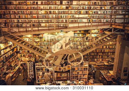 Lisbon, Portugal: Artworks And New Books Inside The Popular Bookstore Ler Devagar With High Bookshel
