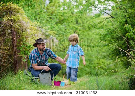 Take Care Of Plants. Boy And Father In Nature With Watering Can. Gardening Tools. Dad Teaching Littl