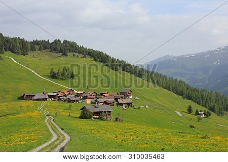 Old Village Obermutten And Green Meadow With Yellow Flowers, Switzerland.