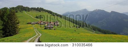 Village Obermutten And Mountain Range, Canton Of Grisons, Switzerland.