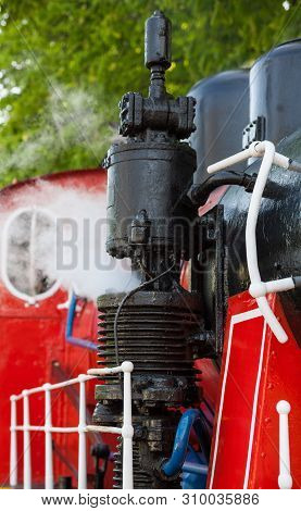 Old Steam Locomotive Blowing Off The Steam Out Of The Whistle.