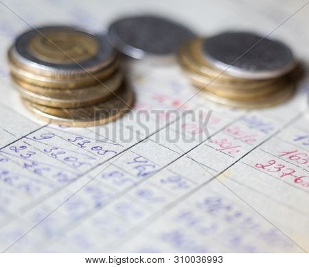 Hand-written Calculations And Coins. Bookkeeping (accounting). Economy. Financial Themes. Money Savi
