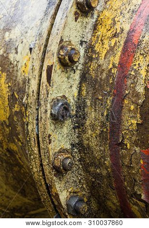 Bolt Coupling On The Old Metal Pipe (tube). Pipeline. Cracked And Damaged Yellow And Red Paint On Th