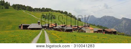 Timber Church And Chalets In Obermutten, Switzerland.
