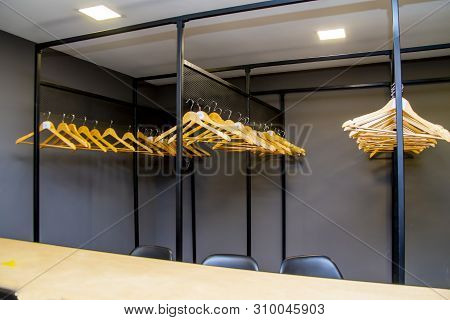 Bright Wooden Hangers With Numbers In Empty Cloakroom Or Checkroom Or Wardrobe