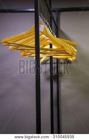 Bright Wooden Hangers With Numbers In Empty Cloakroom Or Checkroom Or Wardrobe