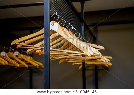 Bright Wooden Hangers With Numbers In Empty Cloakroom Or Checkroom Or Wardrobe