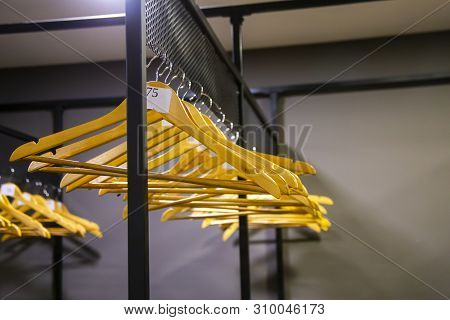 Bright Wooden Hangers With Numbers In Empty Cloakroom Or Checkroom Or Wardrobe