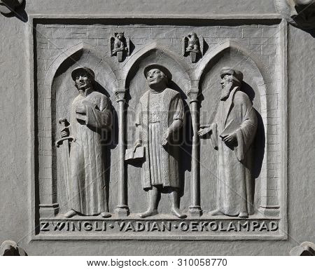 ZURICH, SWITZERLAND - JUNE 23, 2018: Fathers of the Reformed Churches of Switzerland: Zwingli, Vadian, Oecolampadius, relief on the door of the Grossmunster (