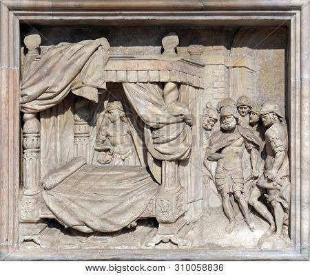 MILAN, ITALY - JUNE 22, 2018: Messengers of King Saul searching for David in order to kill him, marble relief on the facade of the Milan Cathedral, Duomo di Santa Maria Nascente, Milan