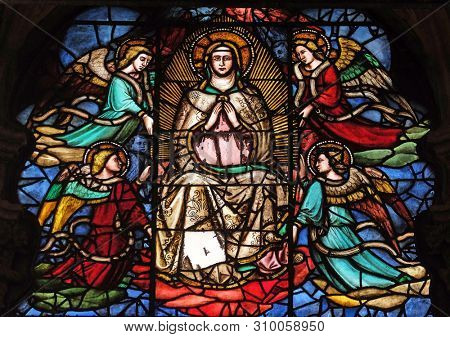 FLORENCE, ITALY - JANUARY 09, 2019: Virgin Mary surrounded by angels, stained glass window in Orsanmichele Church in Florence, Tuscany, Italy