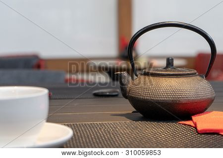 Photo Of Cast Iron Kettle Under Warm Light