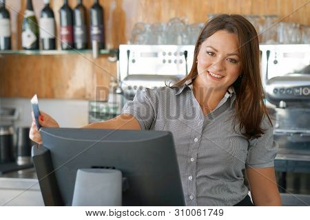 Bartender Registrating New Order By Cash Register. A Restaurant Worker Registrating New Order By Cas
