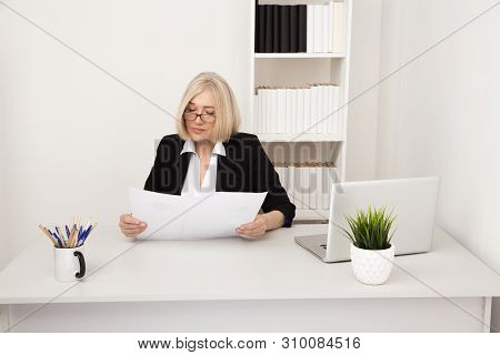 Elegant Businesswoman In Glassess Working In The White Office With Paper.