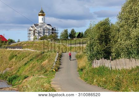 View Of The Winding Village Road And Church On A Hill. Village Of Visim, Sverdlovsk Region, Russia.