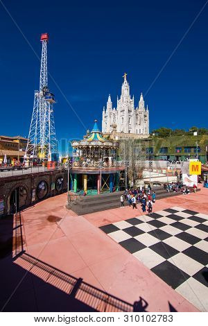 Barcelona, Spain - April, 2019: The Tibidabo Amusement Park On Mount Tibidabo On Background Of Blue