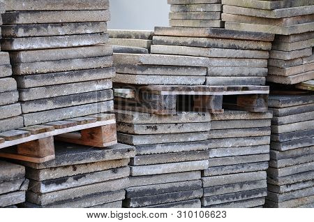 Close-up Of Concrete Floor Plates Stacked Up With Wooden Palettes At Construction Site