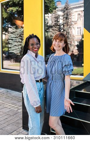 Cauasian And Muslim Women, Best Friends Posing At Camera At The Street. Multiracional Friendship And