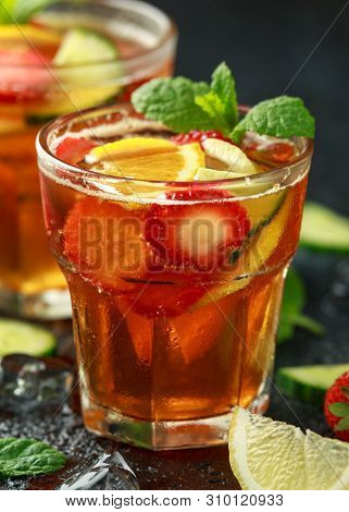 Refreshing Pimms Cocktail With Fruit And Vegetables On Rustic Black Table