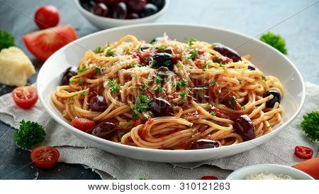 Pasta Alla Puttanesca With Garlic, Olives, Capers, Tomato And Anchois Fish