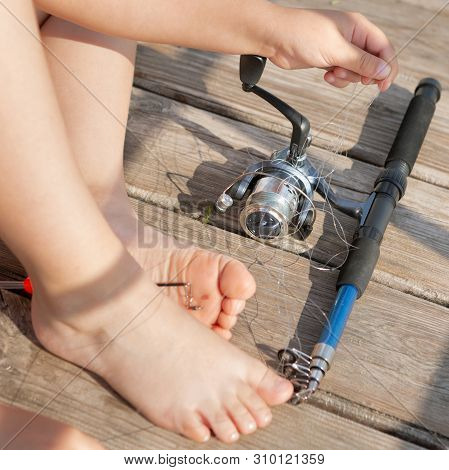 Boys Hands And Fishing Rod, Fishing Line Tangled Fishing Line, A Large Knot, Concept, Close-up