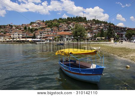 Ohrid, Macedonia - June 10, 2019: Fishing Boat In The Background Historical Part Town Ohrid, Unesco 