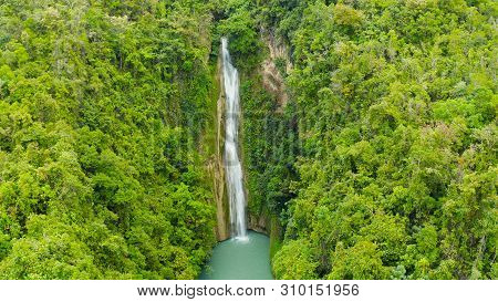 Beautiful Waterfall In Green Forest, Top View. Tropical Mantayupan Falls In Mountain Jungle, Philipp