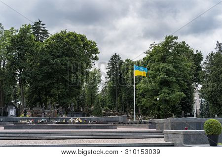Lviv, Ukraine - July 2, 2019: Ukrainian Flag Fluttering On A Lychakiv Cemetery In Lviv, Ukraine.