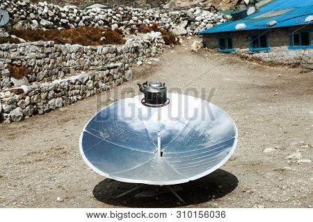 Warming The Teapot In A Solar Cooker. Ecology Concept. Renewable Green Energy. Nepal. Himalaya.