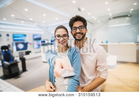 Beautiful Young Girl With Glasses And A Handsome Young Man Stand