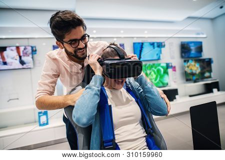 Lovely Cheerful Modern Couple Testing Vr In The Electronic Store.